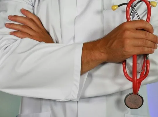 Doctor holding stethoscope representing medical advocacy and anticipatory grief caregiver support