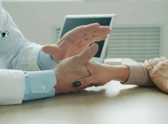 Doctor providing comfort holding patient hands
